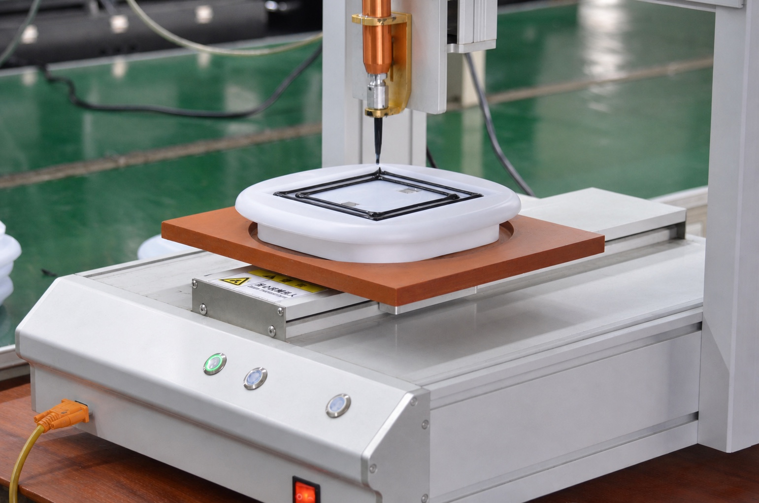 Automated dispensing system applying sealant around a product housing