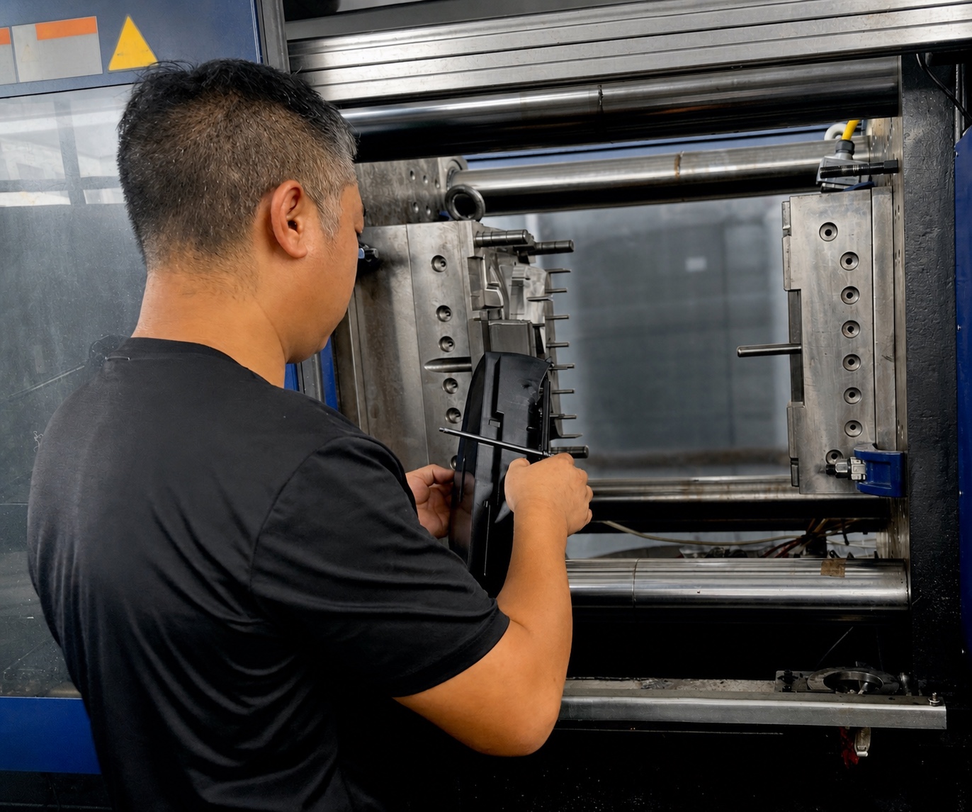 Injection molding operation producing a black molded product component
