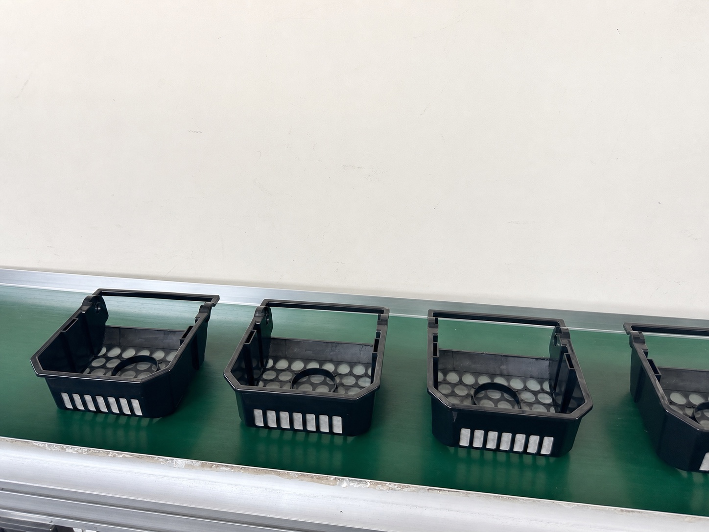 A row of robotic skimmer collection-basket samples produced during mold trials